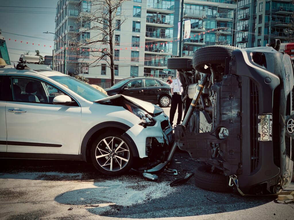 Damaged car from a collision in Sugar Land, Texas, showing significant impact to the front and side.