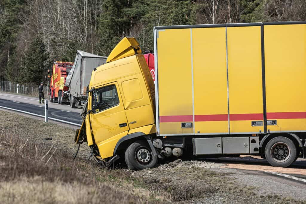 A yellow truck parked on the roadside following an accident on a highway in Houston.