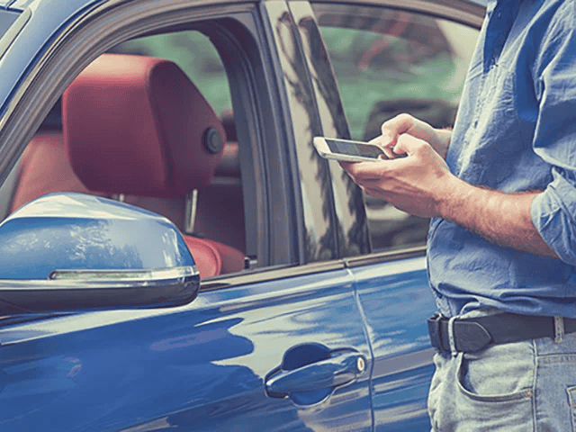 blue-car-man-standing-by-the-door